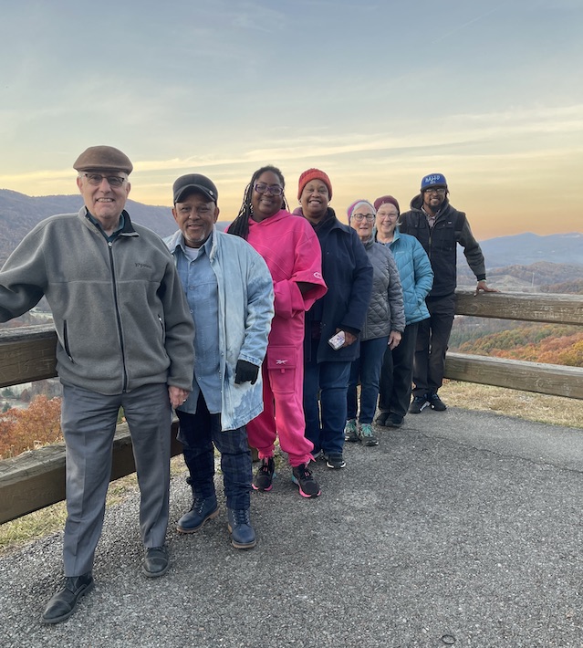 A group of Faith and Money Network members pose with friends from the Southern Appalachian Mountain Stewards at the Powell Valley outlook in Virginia.